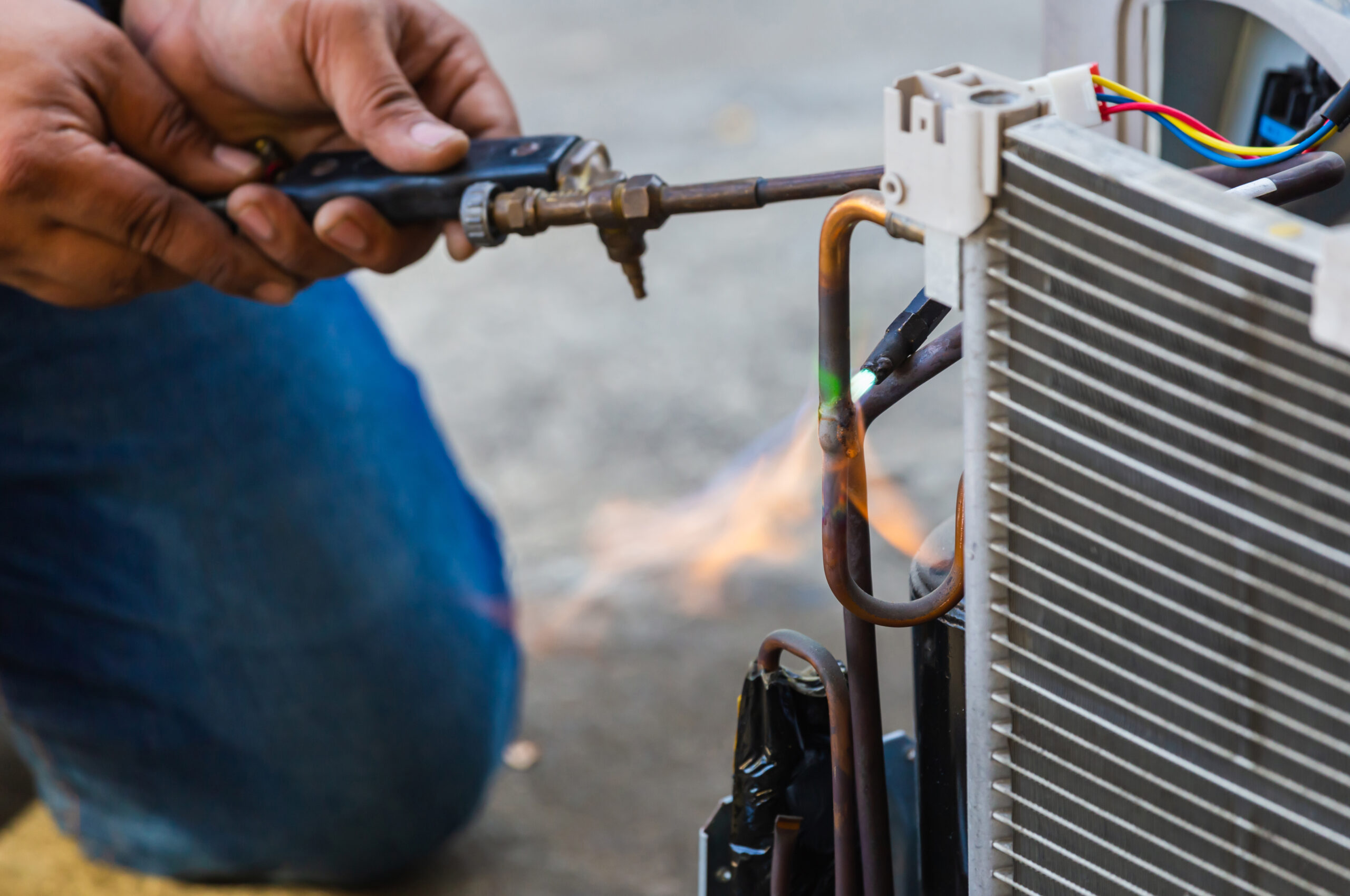 Air Conditioning Repair use fuel gases and oxygen to weld or cut metals, Oxy-fuel welding and oxy-fuel cutting processes, repairman on the floor fixing air conditioning system